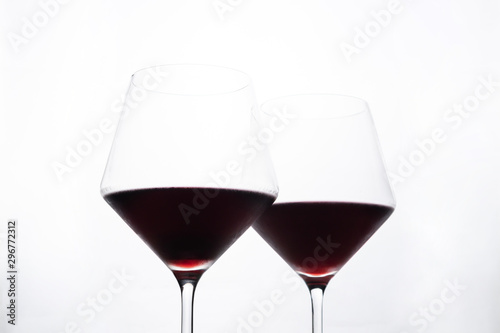 A glasses of red wine close-up on a light background. Minimalism. Copy space. The concept of tasting, wine selection.