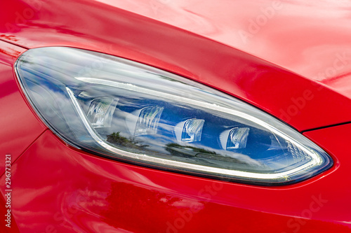 Front light of a red car © yakub88