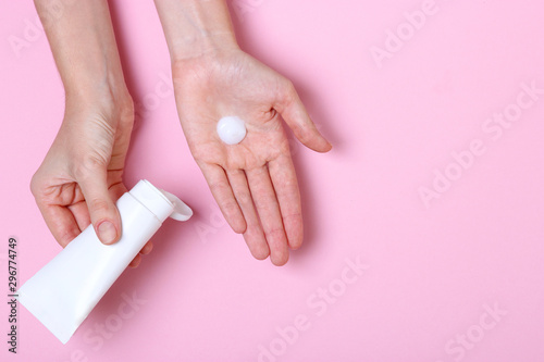 girl smears her hands cosmetic cream. skin care, elastic and young skin of the hands. top view. 