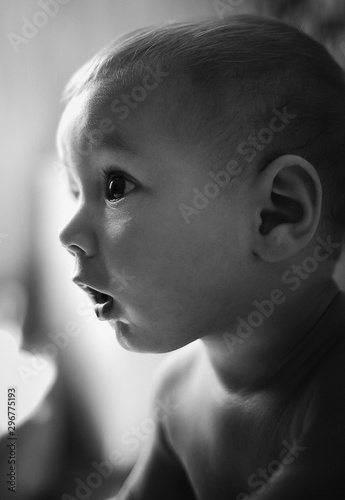 newborn baby portrait with funny shocked face expression. Black and white photo