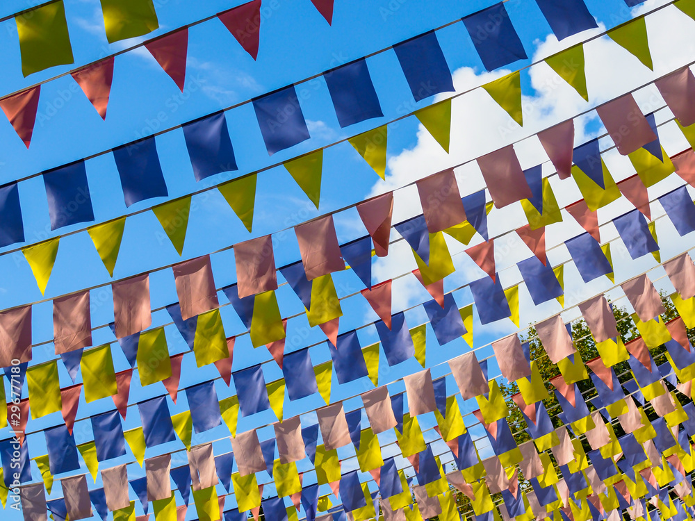 Fototapeta premium National holiday. Colourful flags and the sky