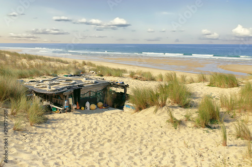 Cozy wooden hut on wild beach photo