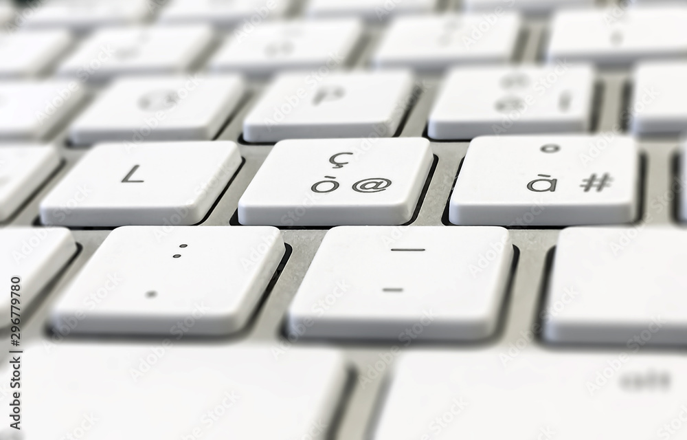 Close-up detail of a computer keyboard with white keys and a gray background Close-up detail of a computer keyboard with white keys and a gray background