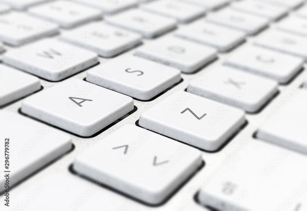 Close-up detail of a computer keyboard with white keys and a gray background Close-up detail of a computer keyboard with white keys and a gray background