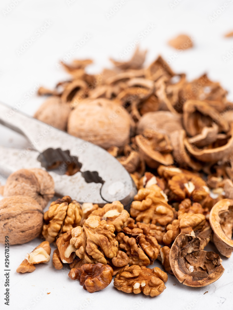 Chopped walnuts with kernels on a gray surface. Chopped walnuts with kernels on a gray surface.