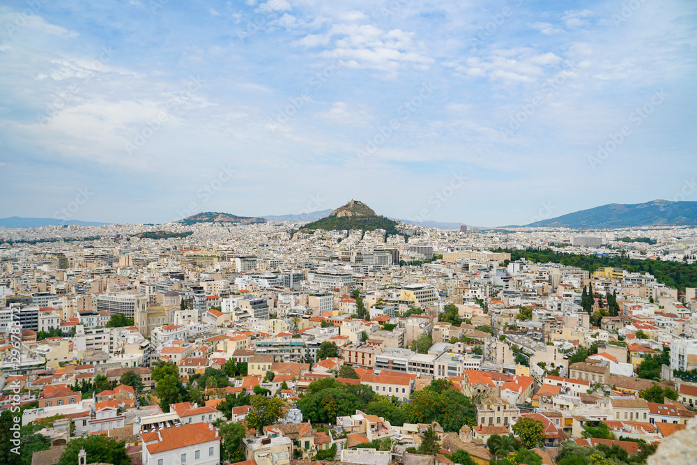 Urban Athens spreading out below with landmark Mount Lycabettus in centre of image