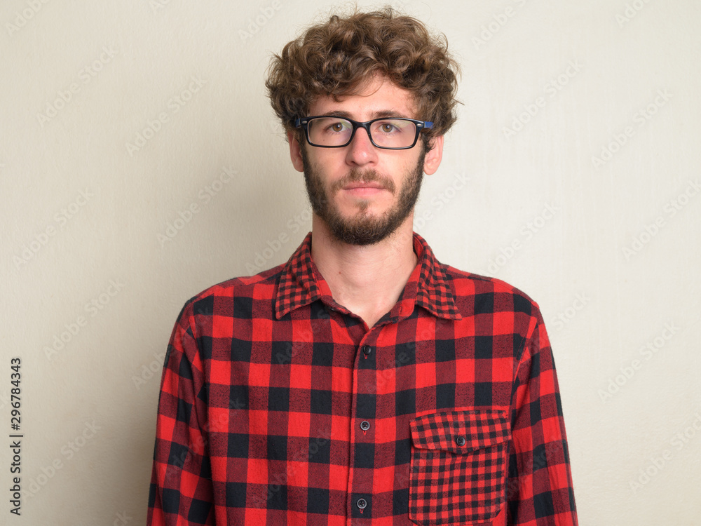 Face of young bearded hipster man with curly hair Face of young bearded hipster man with curly hair