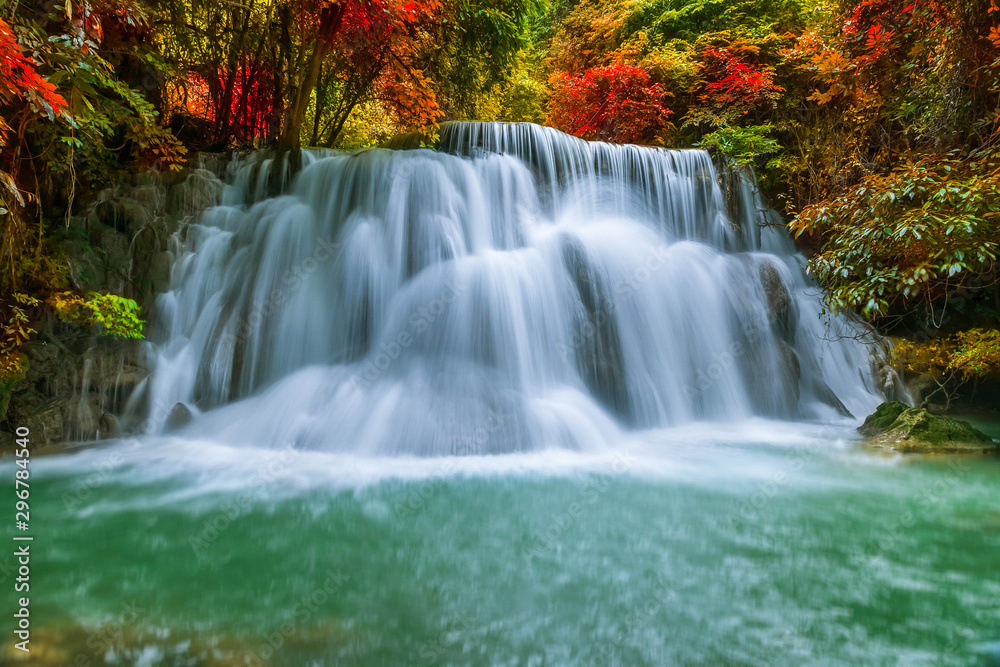 Colorful majestic waterfall in national park forest during autumn - Image