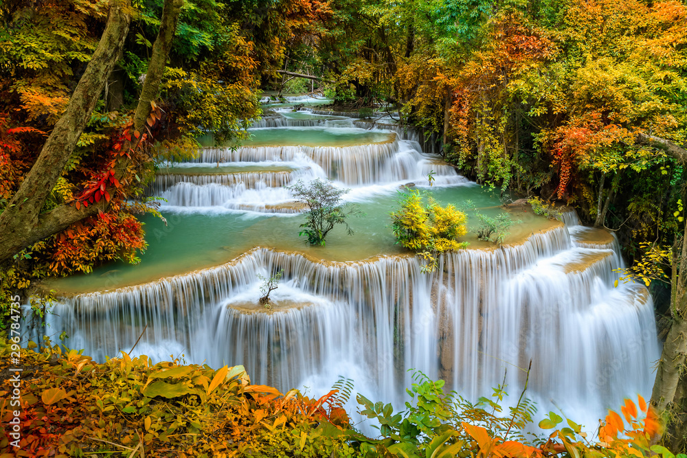 Fototapeta Colorful majestic waterfall in national park forest during autumn - Image