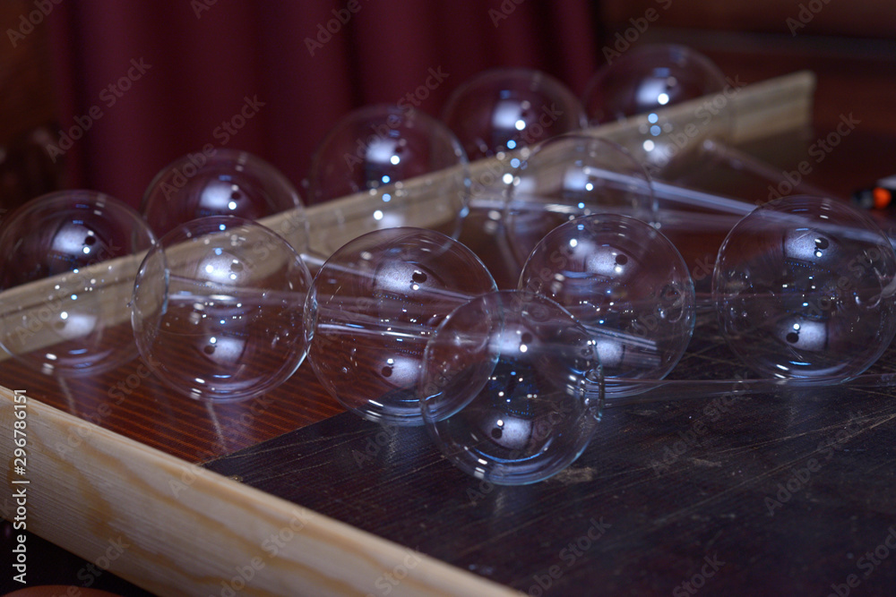 Glassblowing. Blanks of Christmas decorations, balls, placed on a work table