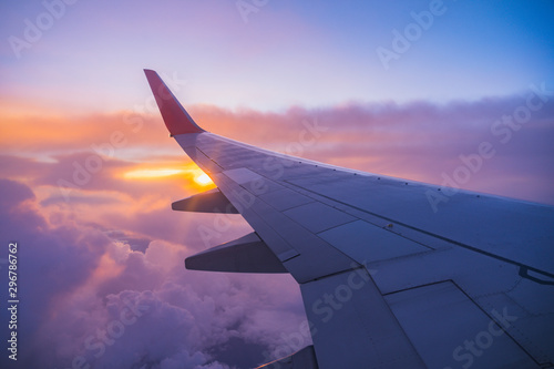 Beautiful sunset, sky on the top view, airplane flying view from inside window aircraft of Traveling. © BBbirdZ