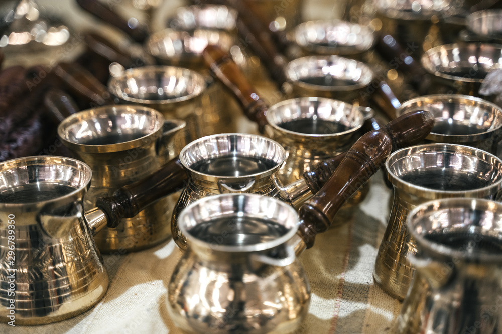 Turkish copper coffee pots with ornaments on a counter in a Turkish bazaar