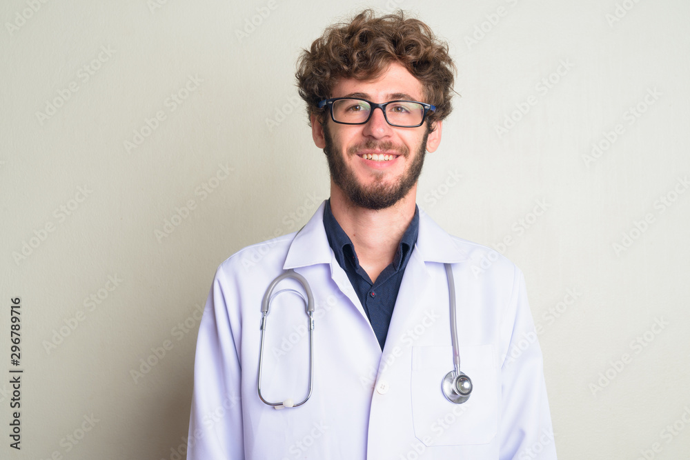 Face of happy young bearded man doctor with eyeglasses smiling Face of happy young bearded man doctor with eyeglasses smiling