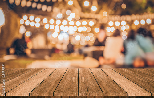 wooden table in front of abstract blurred restaurant lights background