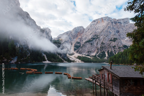 Italy, Lago di braies, Dolomites alps. Alpine lake, along shore of wooden boats.