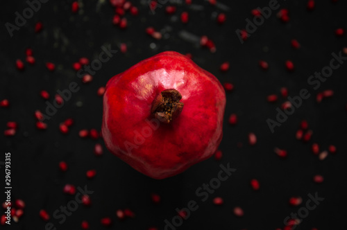 pomegranate on black background, pomegranate seeds