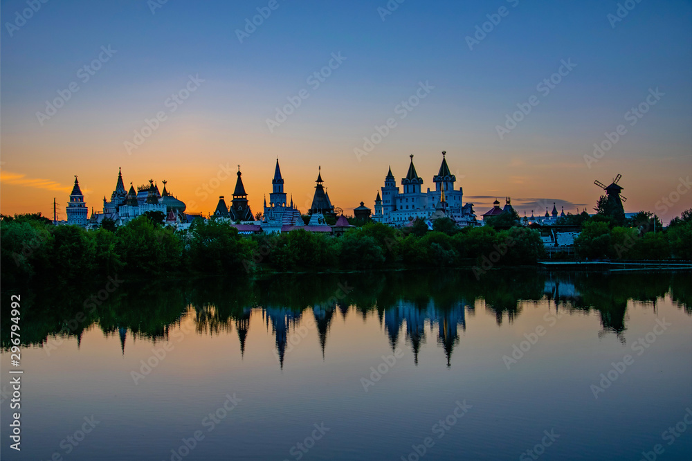 Scenic water reflection of the Izmailovo Kremlin at sunset