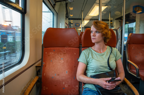 A young woman travels on a train to discover new places of interest in the world