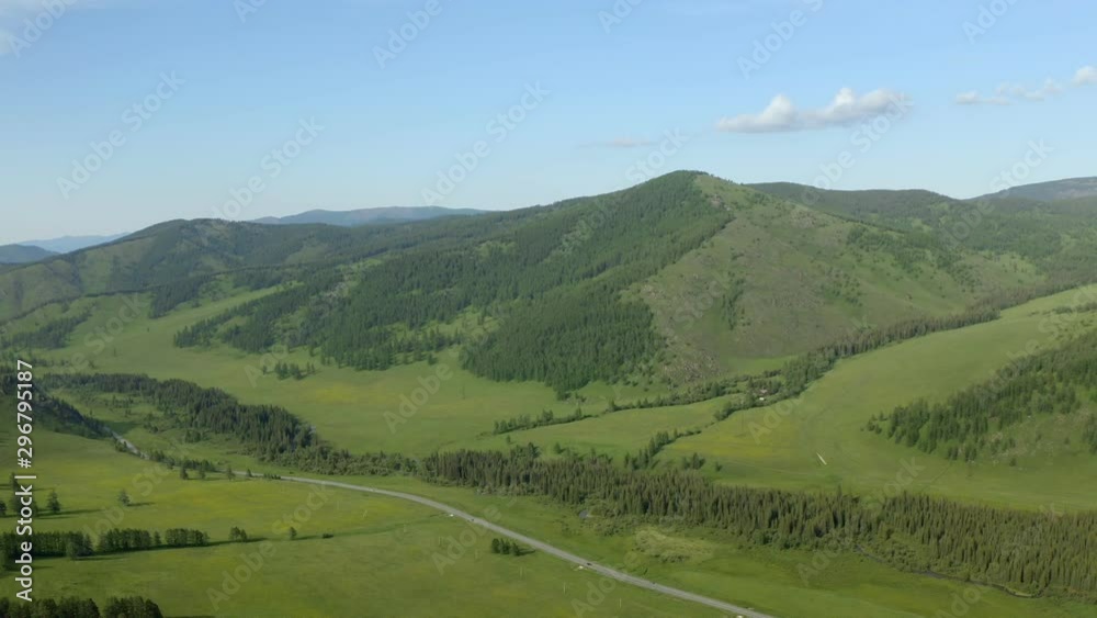 Aerial View of Scenic Drive on a Countryside Road with Mountain Range in Background during Summer Day in Europe Aerial View of Scenic Drive on a Countryside Road with Mountain Range in Background during Summer Day in Europe