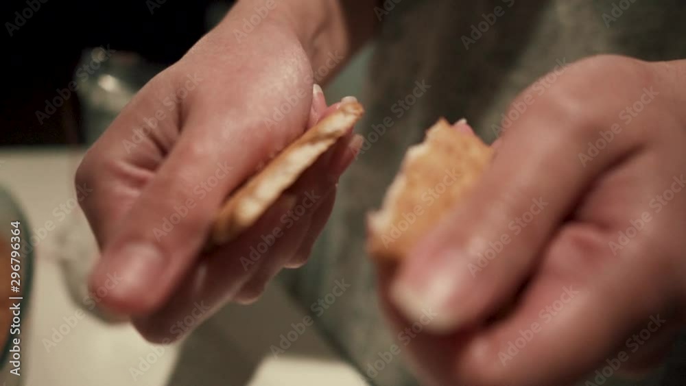 Caucasian person cracking biscuit in slow motion Caucasian person cracking biscuit in slow motion