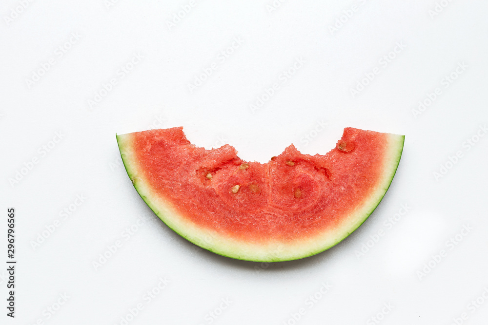 Slice of watermelon on a white background. Bite marks on a slice of watermelon. Slice of watermelon on a white background. Bite marks on a slice of watermelon.