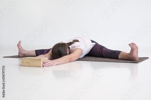 upavistha konasana or wide angle seated forward bend pose. Woman working out doing yoga asana variation.
