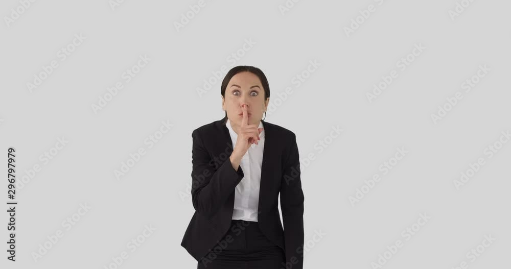 Shocked businesswoman with finger on lips over white background Shocked businesswoman with finger on lips over white background