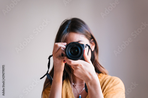 photographer woman at home holding a camera. Technology and lifestyle indoors