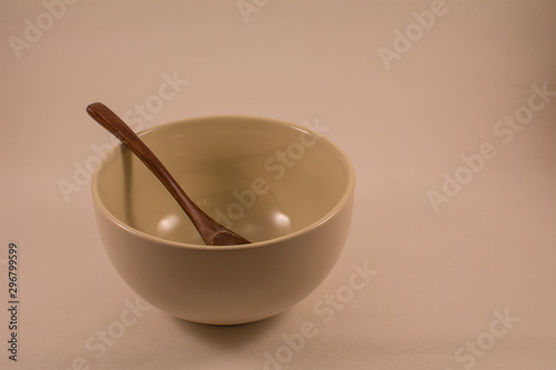 Spoon in bowl on a light background