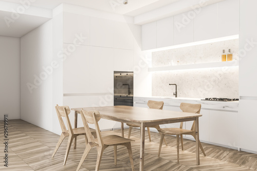 White kitchen corner with wooden table © ImageFlow