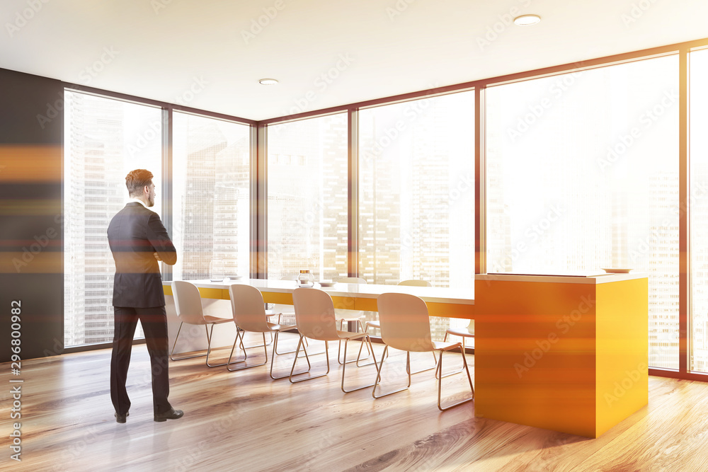 Fototapeta premium Man in gray panoramic dining room