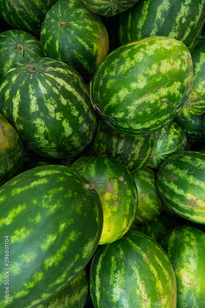watermelon with stripe pattern for background at farmer's market or grocery store, vertical photo watermelon with stripe pattern for background at farmer's market or grocery store, vertical photo