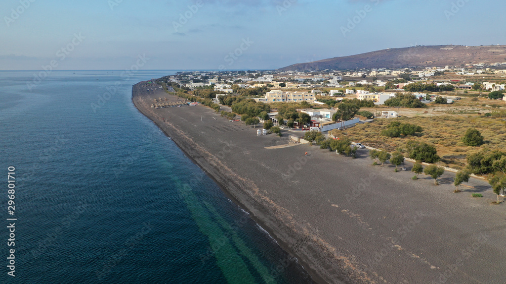 Aerial drone photo of famous volcanic beach and bay of Perissa village, Santorini island, Cyclades, Greece