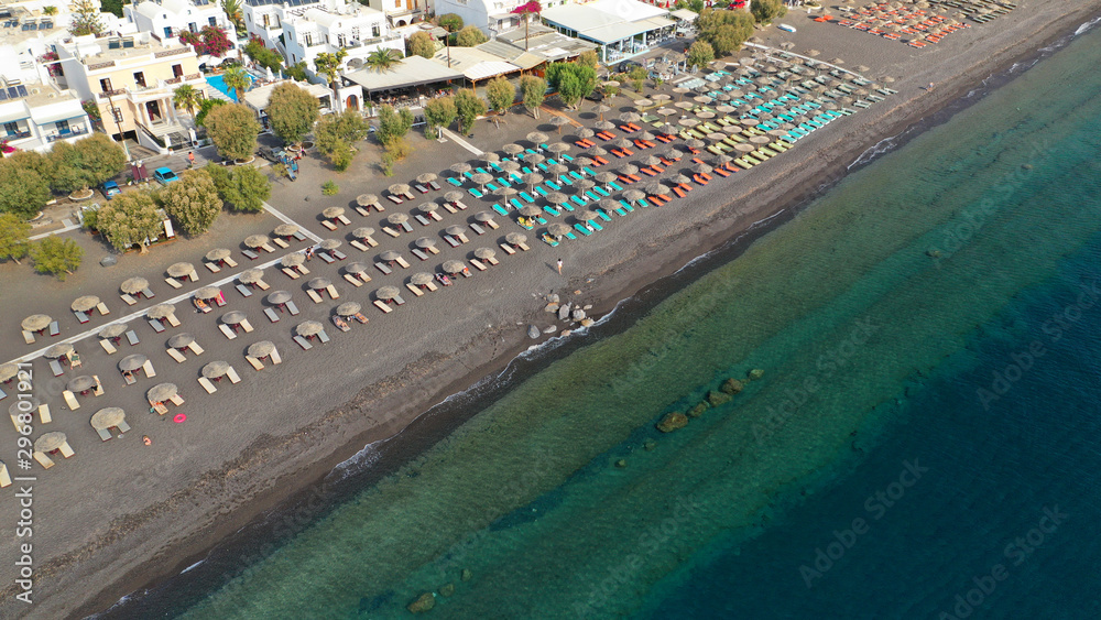 Aerial drone photo of famous volcanic beach and bay of Perissa village, Santorini island, Cyclades, Greece