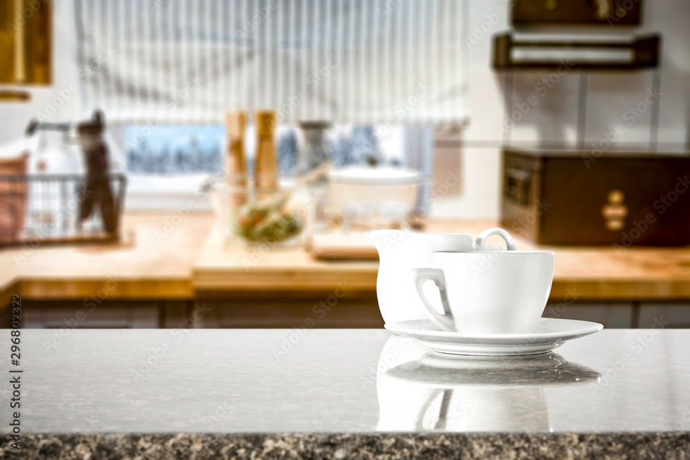 Kitchen table top with empty space for you products or decoration and blurred kitchen furniture background.