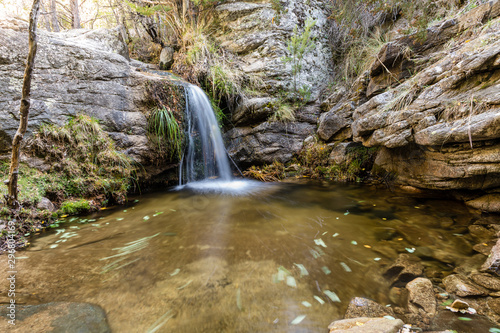 Fototapeta Naklejka Na Ścianę i Meble -  Small waterfall in a stream in the mountains of Madrid, right in La Pedriza