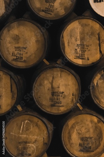 Stacked tequila barrels in a winery