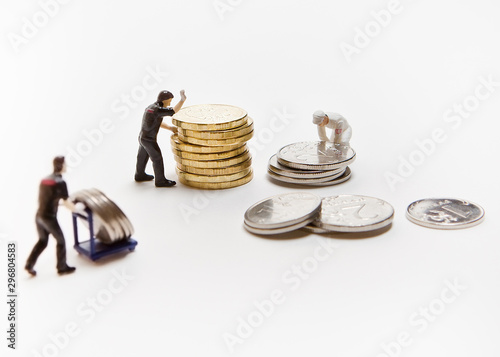 People-dolls with Russian coins on a white background