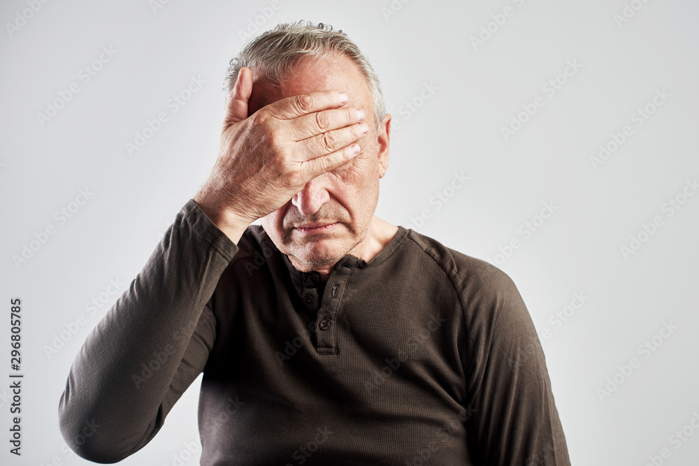 elderly gray-haired man with expression of pain on face put his hand on head, feels dizzy and cluster headache, migraine, high or low blood pressure isolated on white elderly gray-haired man with expression of pain on face put his hand on head, feels dizzy and cluster headache, migraine, high or low blood pressure isolated on white