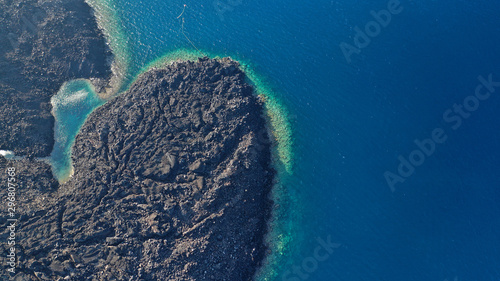 Aerial drone top down photo of iconic main Crater of Santorini volcanic island called Kameni visited by tourist boats, Cyclades, Greece