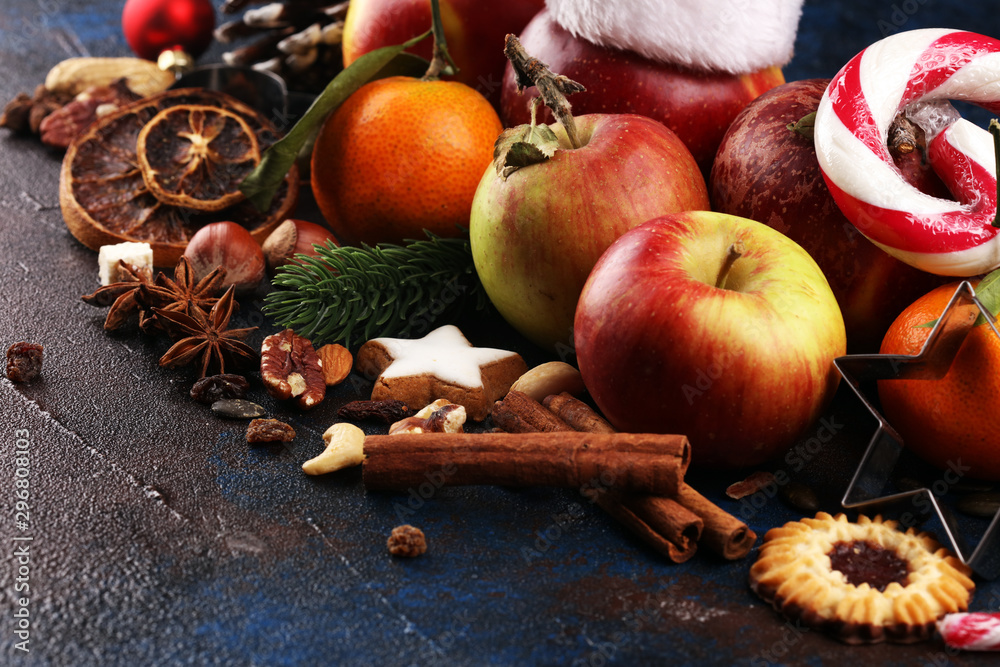 christmas cookies and santa had with spieses, nuts and fruits on rustic table