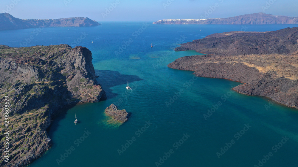 Aerial drone top down photo of iconic main Crater of Santorini volcanic island called Kameni visited by tourist boats, Cyclades, Greece