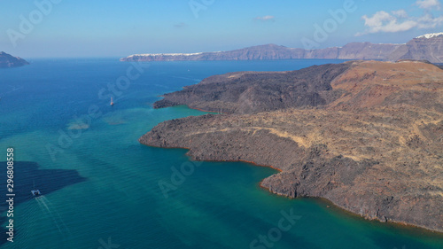 Aerial drone top down photo of iconic main Crater of Santorini volcanic island called Kameni visited by tourist boats, Cyclades, Greece