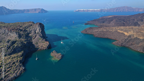 Aerial drone top down photo of iconic main Crater of Santorini volcanic island called Kameni visited by tourist boats, Cyclades, Greece