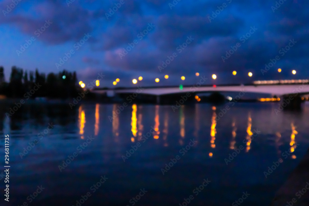 Blurred Nagatinsky bridge over Moscow river. Metro train is moving fast at night. Night Moscow view. Defocused image.