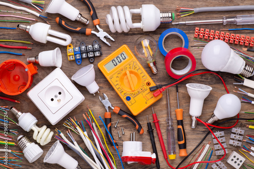 Electrician equipment on wooden background, top view 