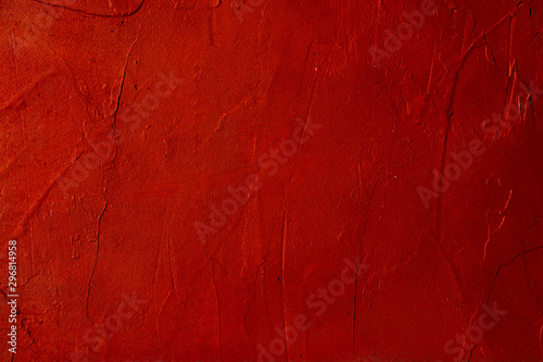 Red textured cement wall closeup.