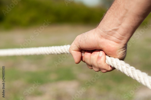 strong male hands hold the rope