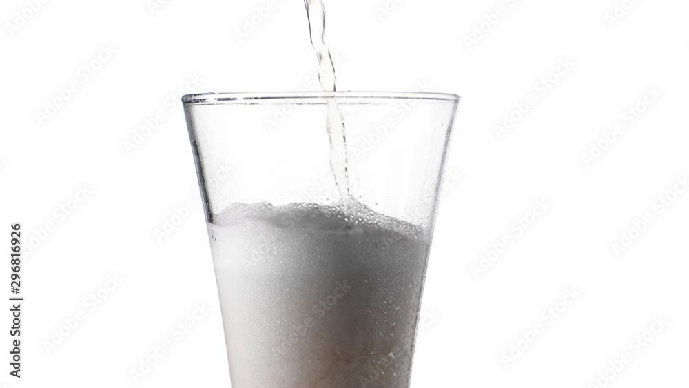 Close-up slow motion: cold Beer is poured into a glass from a bottle on a white background with bubbles in foam Close-up slow motion: cold Beer is poured into a glass from a bottle on a white background with bubbles in foam
