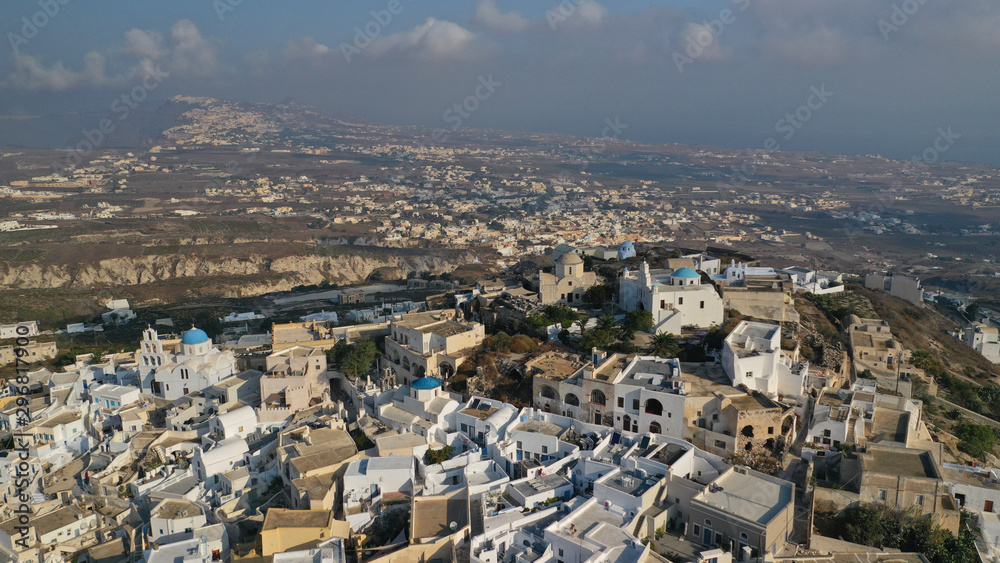 Aerial drone photo of iconic small traditional village and uphill castle of Pyrgos with great views to Santorini island Cladera, Cyclades, Greece
